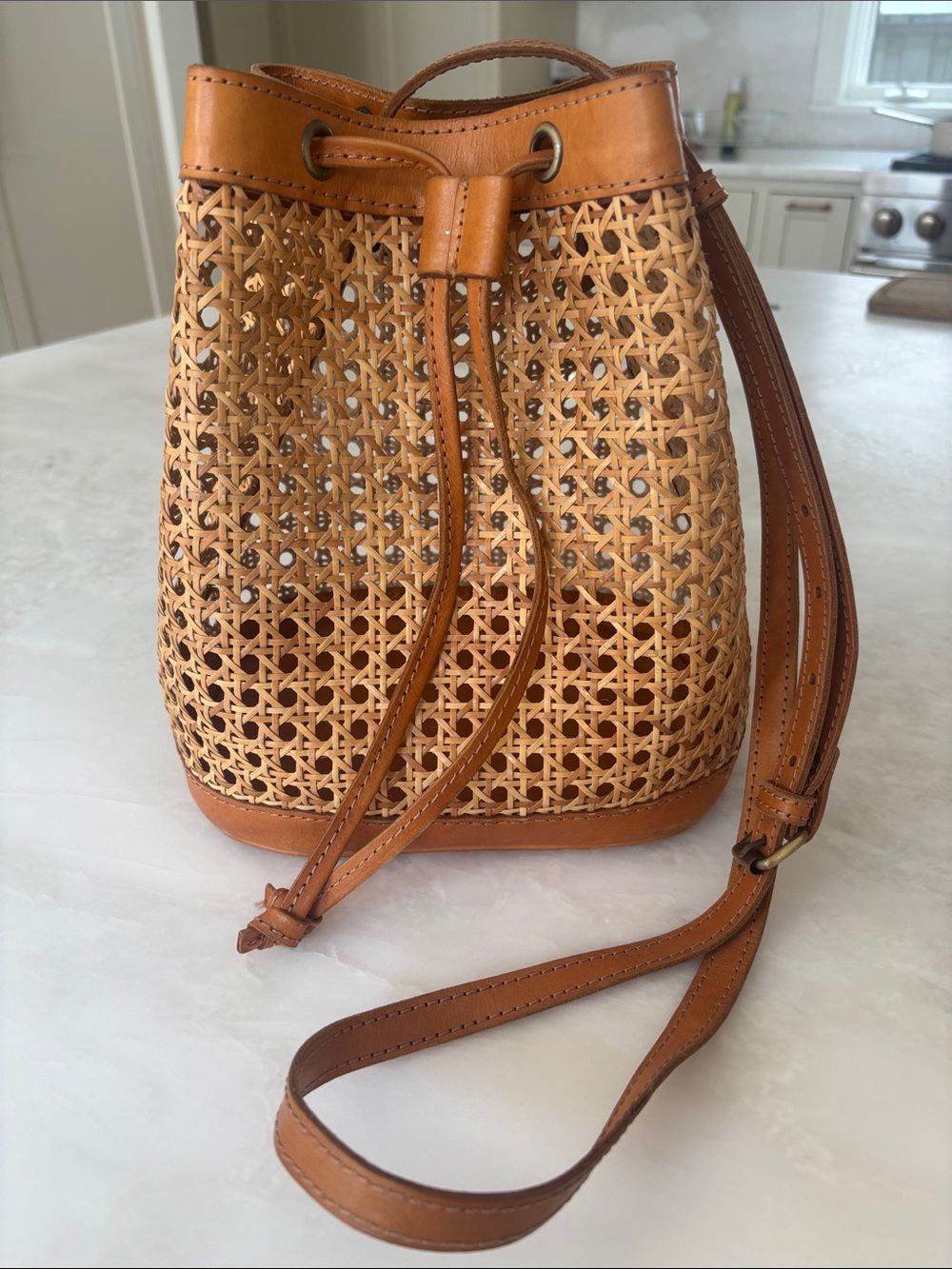 Bembien Benna Woven Rattan Drawstring Bucket Bag in Tan